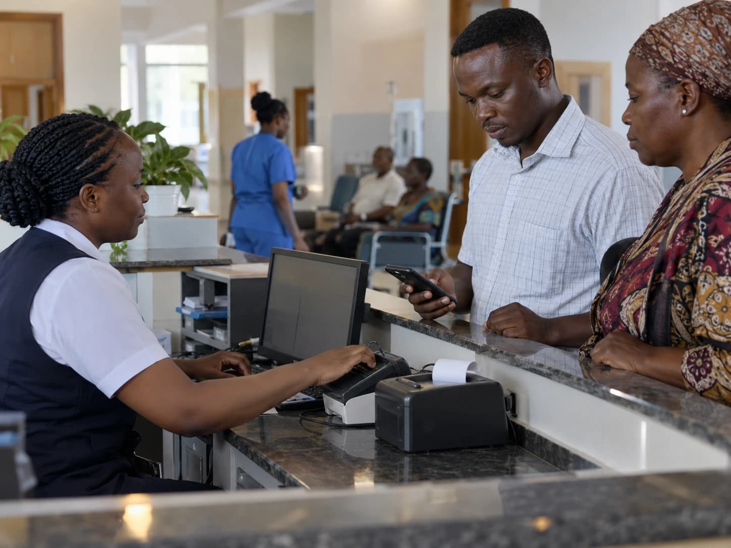 A hospital cashier serving a patient's relative who is paying by mobile phone